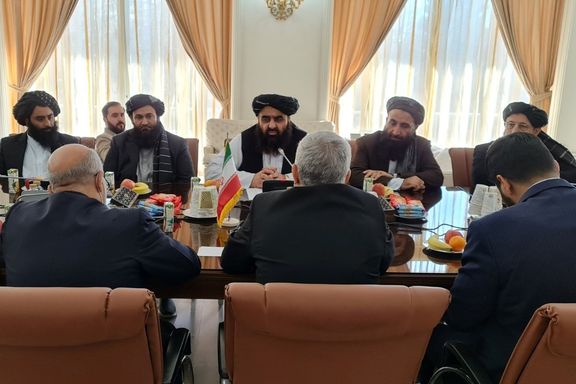 Taliban's acting foreign minister Amir Khan Muttaqi (C) during a meeting with Iranian president's special envoy to Afghanistan Hassan Kazemi Qami on January 9, 2022
