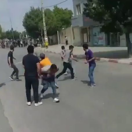 People throw stones at security forces who attacked them to disperse their protests in the Kurdistan province on September 19, 2022