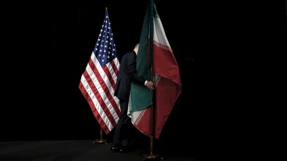 A staff member removes the Iranian flag from the stage after a group picture with foreign ministers and representatives of the U.S., Iran, China, Russia, Britain, Germany, France and the European Union during the Iran nuclear talks at the Vienna International Center in Vienna, Austria July 14, 2015.