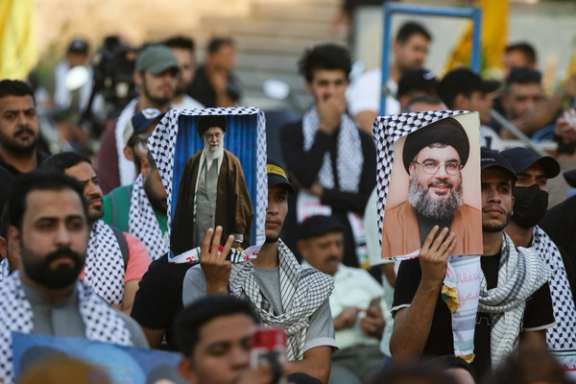 Supporters of Iraqi Shi'ite armed groups gather in Baghdad's Tahrir Square to watch a speech by Hezbollah leader Sayyed Hassan Nasrallah, November 3, 2023.
