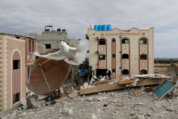 A dove flies over the remains of a house destroyed by Israeli strikes during the conflict, amid a temporary truce between Israel and the Palestinian Islamist group Hamas, in Khan Younis in the southern Gaza Strip November 28, 2023.
