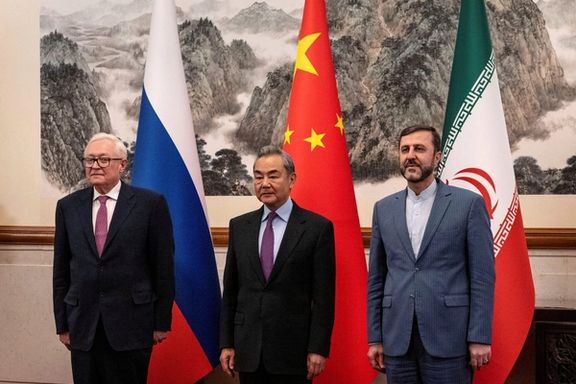 Chinese Foreign Minister Wag Yi, stands with Russian Deputy Foreign Minister Sergey Ryabkov, and Iranian Deputy Foreign Minister Kazeem Gharibabadi in Beijing, March 14, 2025