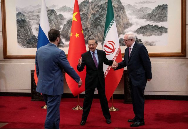 Chinese Foreign Minister Wag Yi welcomes Russian and Iranian deputy foreign ministers Sergey Ryabkov and Kazeem Gharibabadi on March 14, 2025 in Beijing, China.