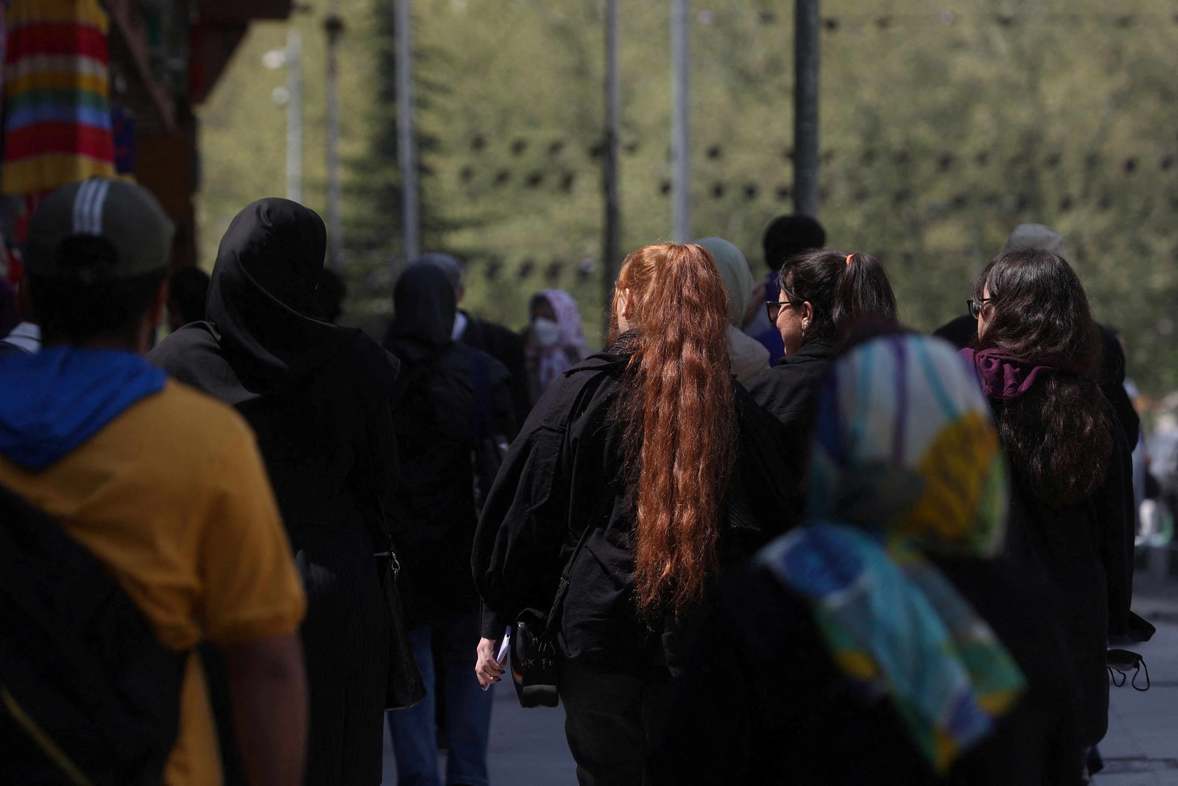 Iranian women walk on a street amid the implementation of the new hijab surveillance in Tehran, Iran, April 15, 2023.