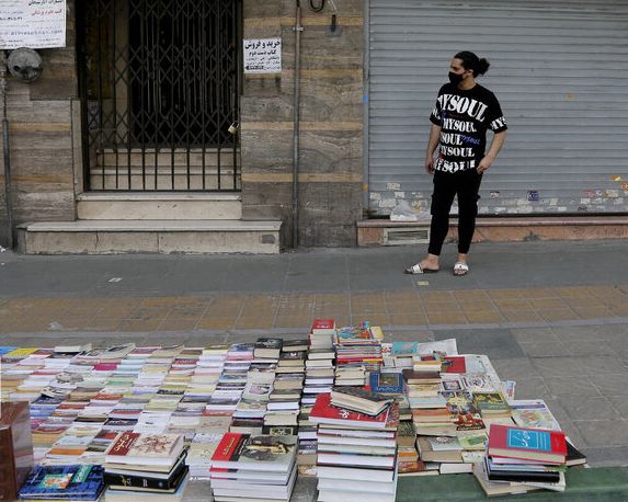 Book sellers in a Tehran street. Undated