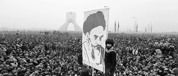 Iranian demonstrator holds poster of Khomeini as uprisings swept Iran in 1978.