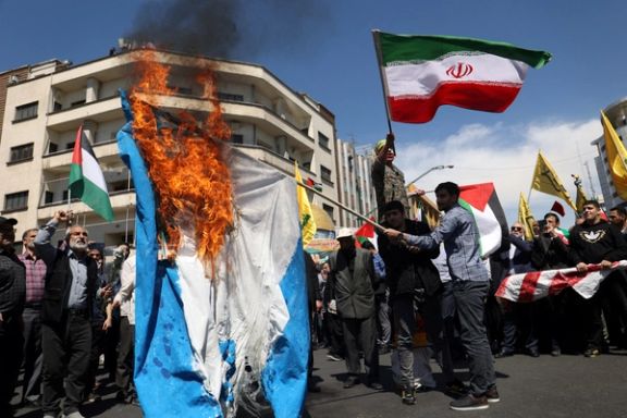 Iranians burn an Israeli flag during a rally marking Quds Day and the funeral of members of the Islamic Revolutionary Guard Corps who were killed in a suspected Israeli airstrike on the Iranian embassy complex in the Syrian capital Damascus, in Tehran, Iran, April 5, 2024.