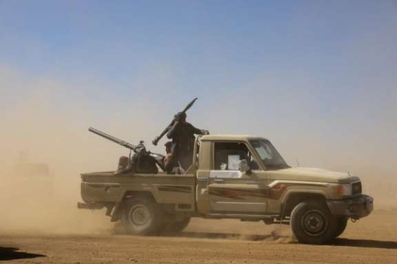 A pick-up truck carrying tribal supporters of the Houthi group parade during a protest against recent US-led strikes on Houthi targets, near Sanaa, Yemen January 14, 2024.