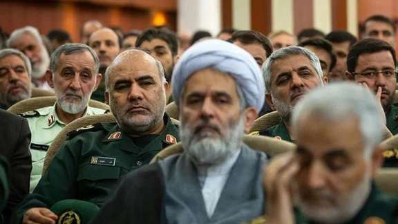 Hossein Taeb seen in this undated photo (C) with IRGC ex-commander Soleimani in foreground