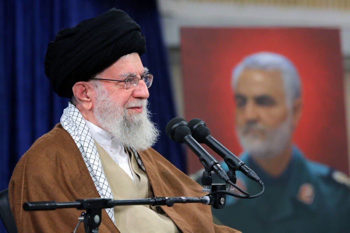 Ali Khamenei speaking on December 23, 2023, with a photo of IRGC Gen, Qasem Soleimani in the background.