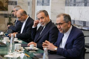 ranian negotiators Abbas Araghchi (center left), Foreign Minister, and Majid Takht-Ravanchi (right), engage in high-level diplomatic talks.