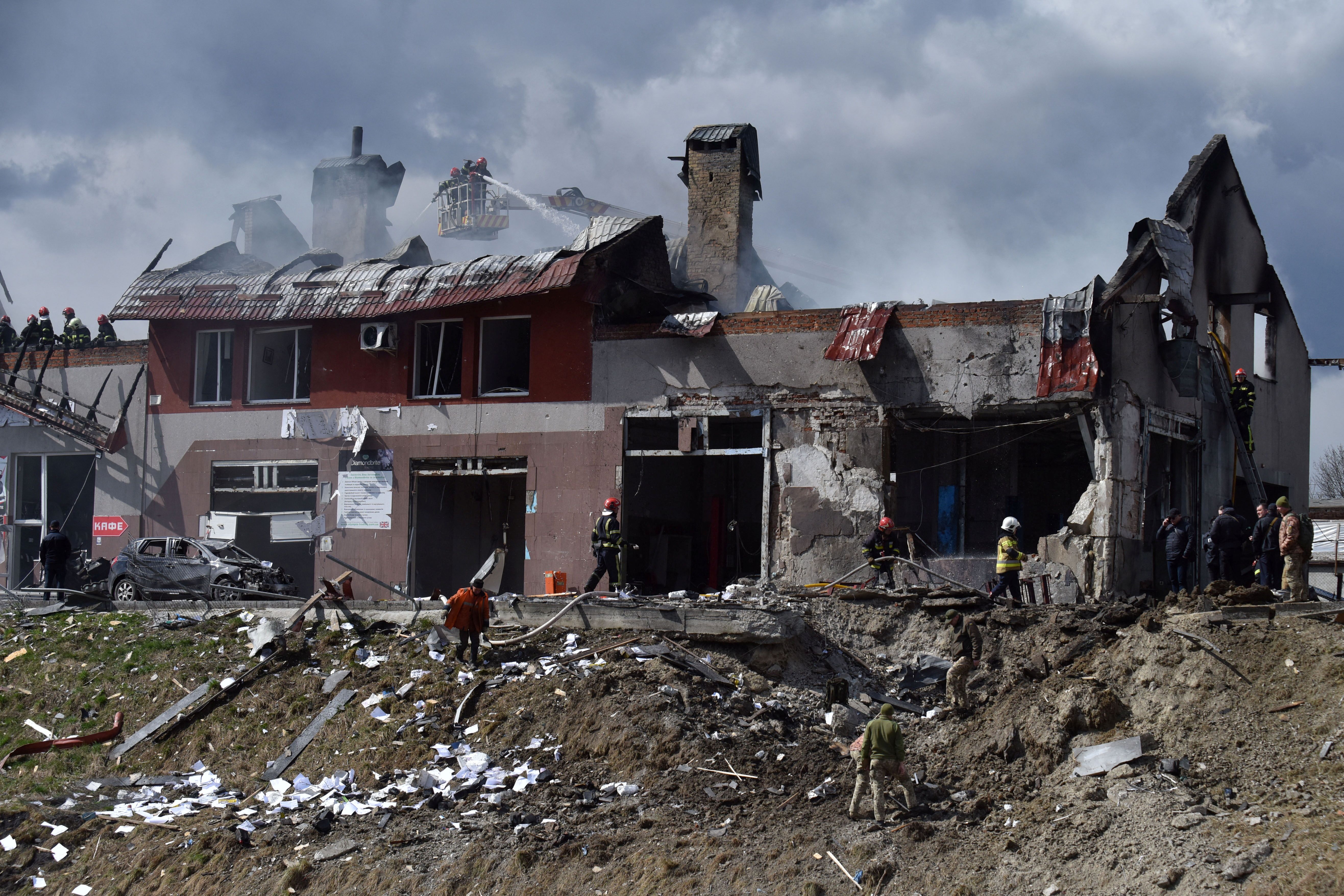 A huge crater next to a damaged building in Lviv after Russian missile strikes. April 18, 2022