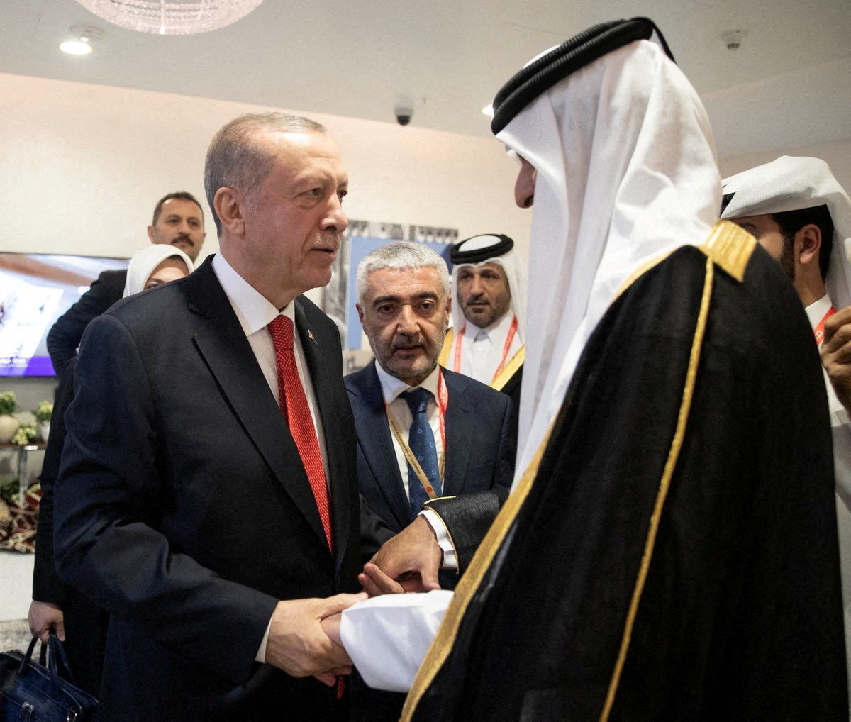 Turkey's President Tayyip Erdogan shakes hands with Qatari Emir Sheikh Tamim bin Hamad Al Thani on the sidelines of the World Cup in Doha, Qatar, November 20, 2022. 