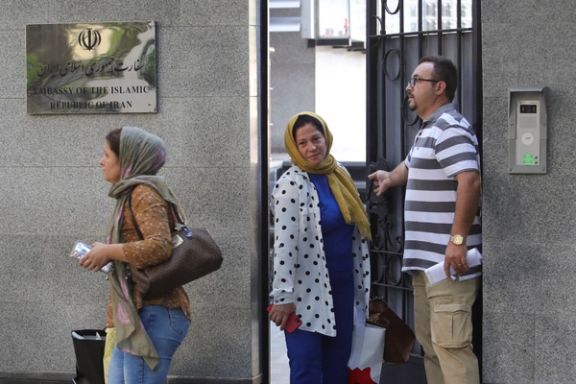 Personnel of Iran's embassy leave the compound on Thursday, Sept. 8, 2022