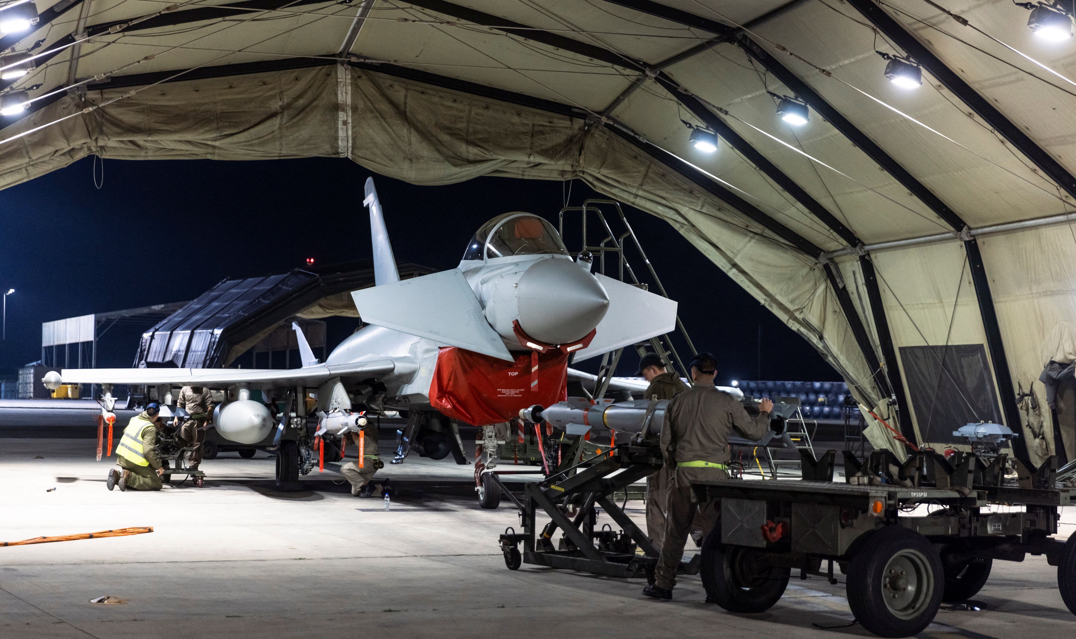 A Royal Air Force Typhoon FGR4 has Paveway IV weapons loaded by Weapon Technicians in support of current ongoing operations against Houthi targets in Yemen, February 22, 2024. 