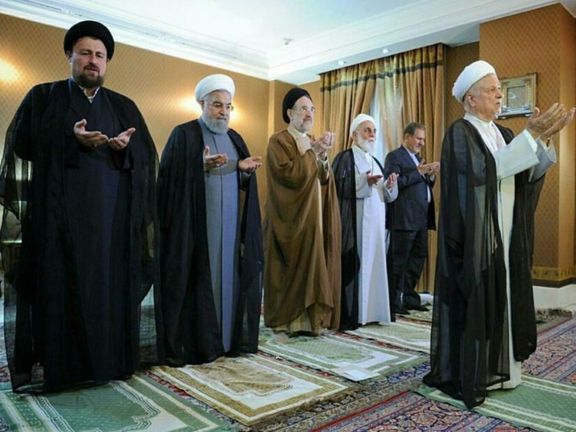Former president Rafsanjani leading a prayer with Khatami (C) and Khomeini's grandson (L) standing behind him. Undated