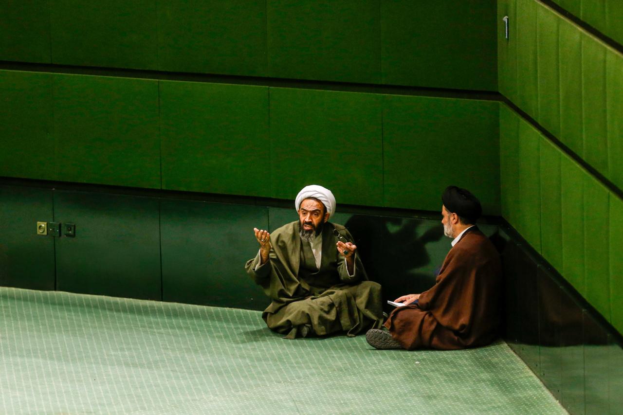 Two lawmakers speaking during a session of the parliament on April 9, 2025