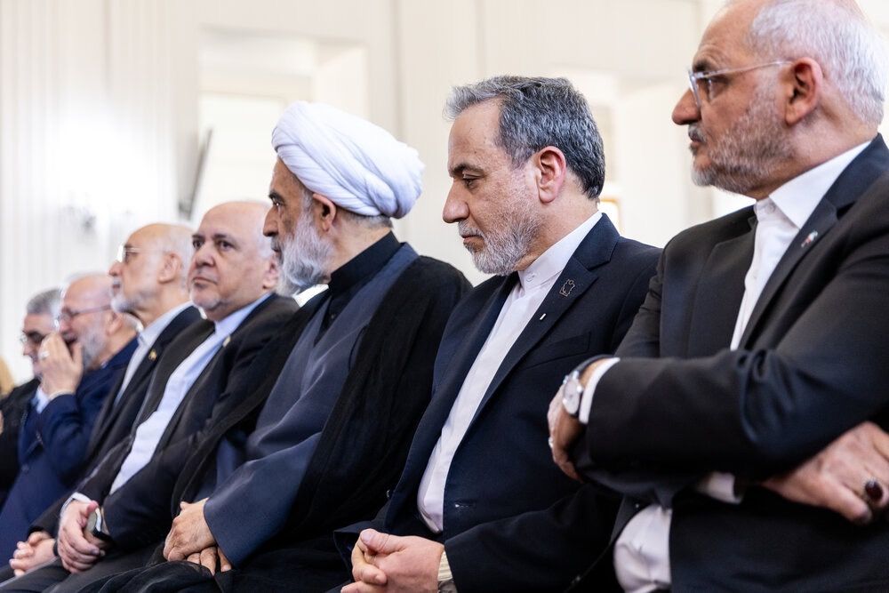Four prominent moderates sit on both sides of senior cleric and supreme leader appointee Mohsen Qomi in an event to honour two former foreign ministers killed in a crash and by US-Israeli attacks, in Tehran, Iran, May 20, 2026. (Left to right: former nuclear chief Ali Akbar Salehi, former foreign minister Mohammad Javad Zarif, Mohsen Qomi, foreign minister Abbas Araghchi, and president Pezeshkian's chief of staff Mohsen Haji-Mirzaei)