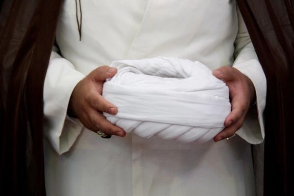 A cleric holding his turban