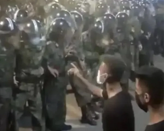 Protesters in Iran confronting a throng of security forces