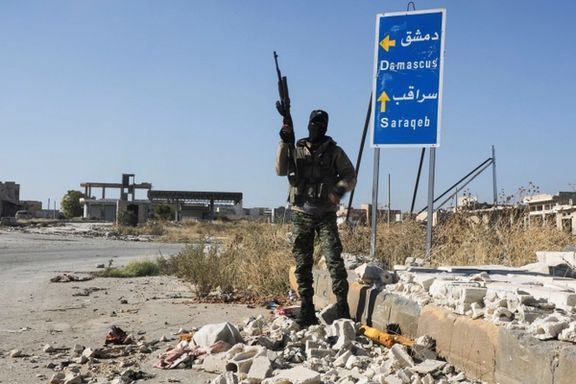 A rebel fighter carries a weapon as he stands at the entrance of Saraqeb town in northwestern Idlib province, Syria December 1, 2024.