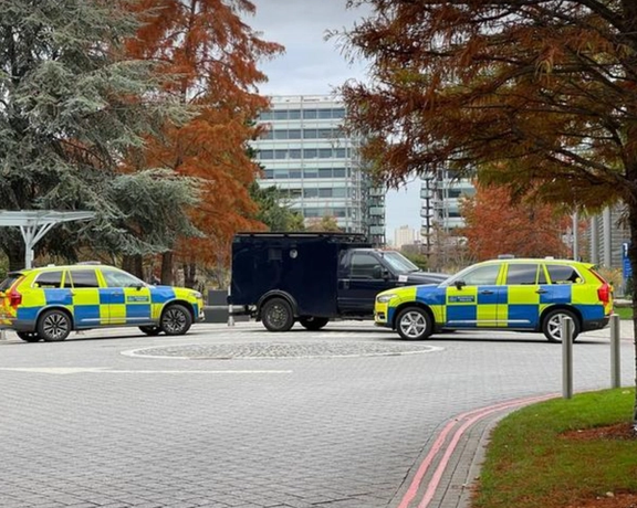 Armored police vehicles are seen outside the headquarters of Iran International in November 2022