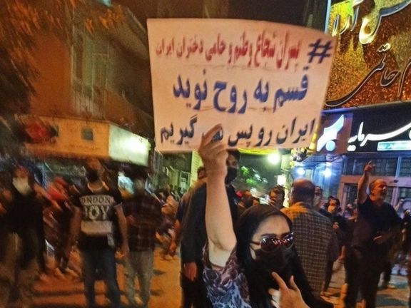 A woman holding a sign in Tehran that says "Brave boys in my country are guardians of Iran's women". October 15, 2022