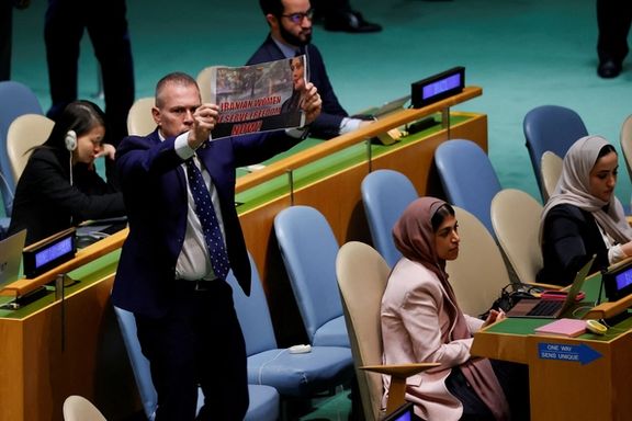 Israel's Ambassador to the United Nations Gilad Erdan leaps up with a sign in support of women's rights in Iran, on the floor of the UN General Assembly before being led out of the hall as Iran's President Ebrahim Raisi was addressing the 78th Session of the General Assembly in New York City, September 19, 2023.