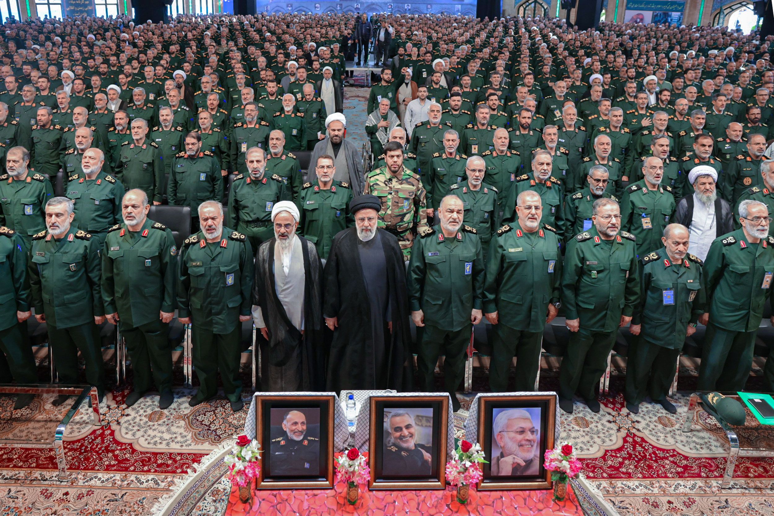 Iranian President Ebrahim Raisi (center) among senior Revolutionary Guards commanders during an event where IRGC Navy released a video of intercepting US Navy ships