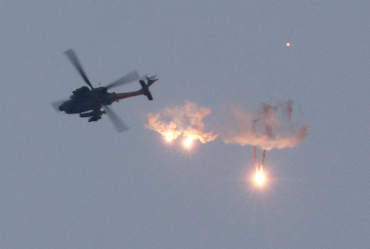 An Apache helicopter fires flares, amid the ongoing conflict between Israel and Palestinian Islamist group Hamas, as seen from Sderot in southern Israel, November 1, 2023. 