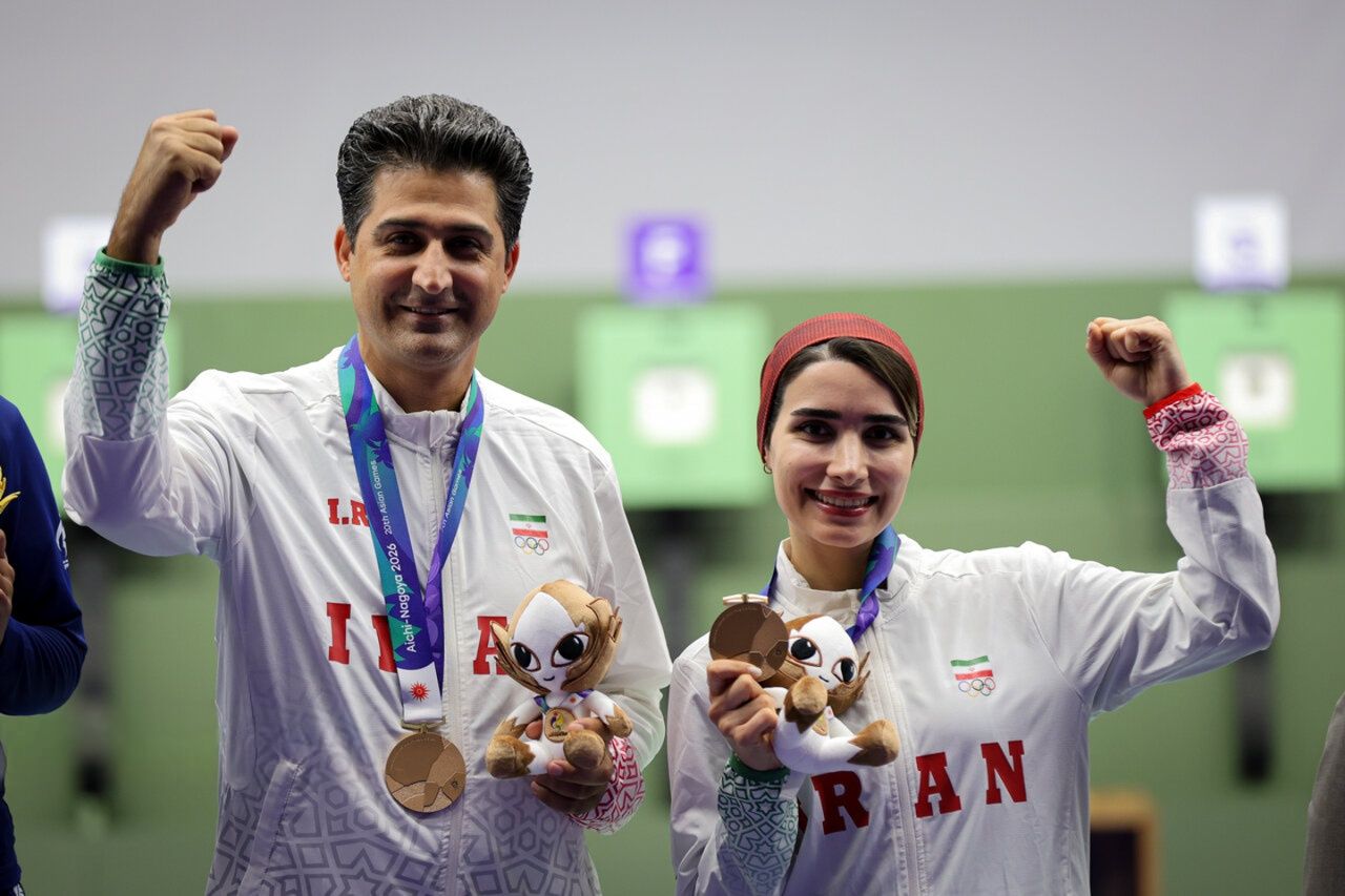 Hanieh Rostamian and Vahid Golkhandan celebrate after winning bronze for Iran in the mixed team shooting event at the 2026 Asian Games.
