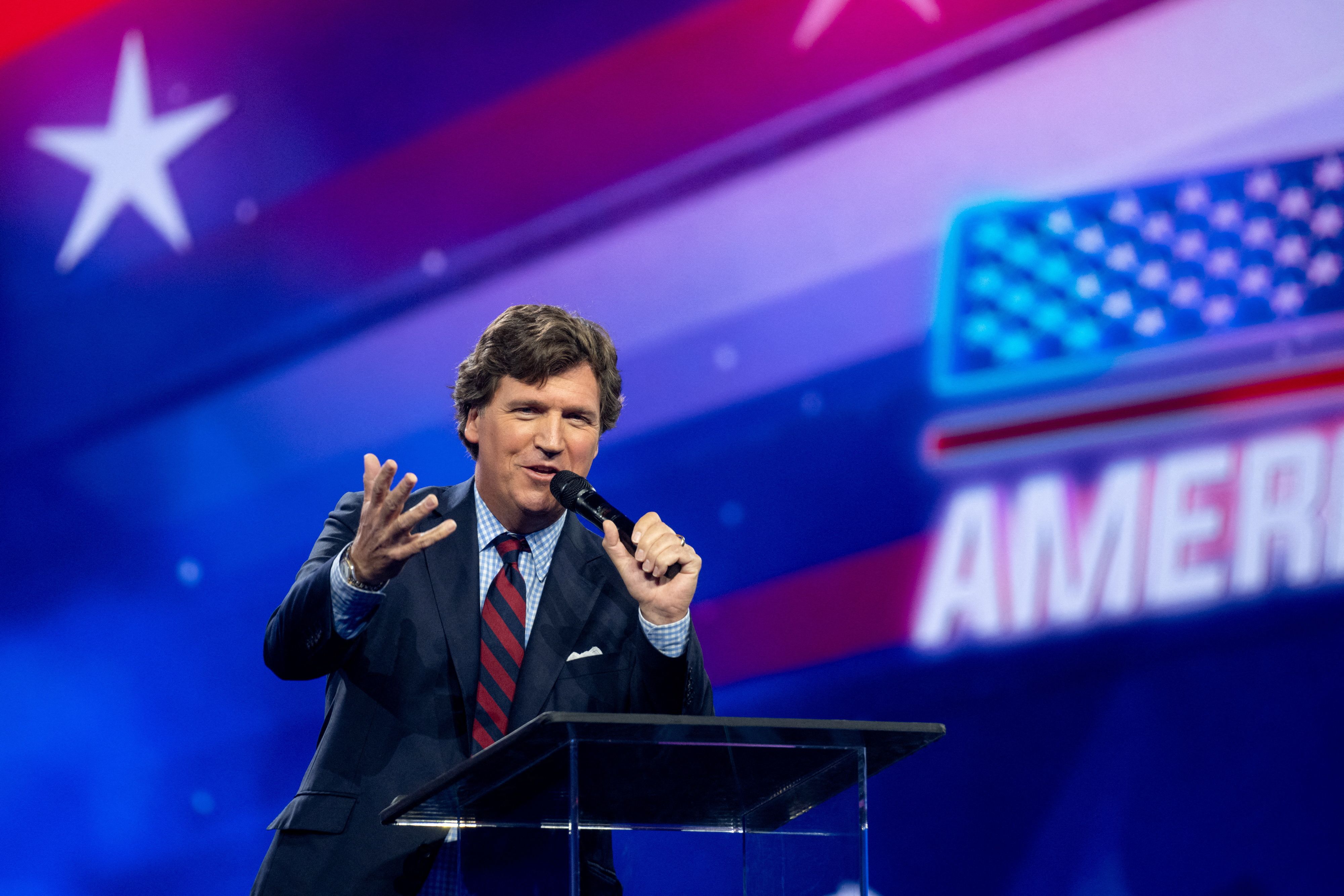 Tucker Carlson speaks as conservative leaders and personalities attend Turning Point USA's AmericaFest 2023 in Phoenix, Arizona, US December 18, 2023.