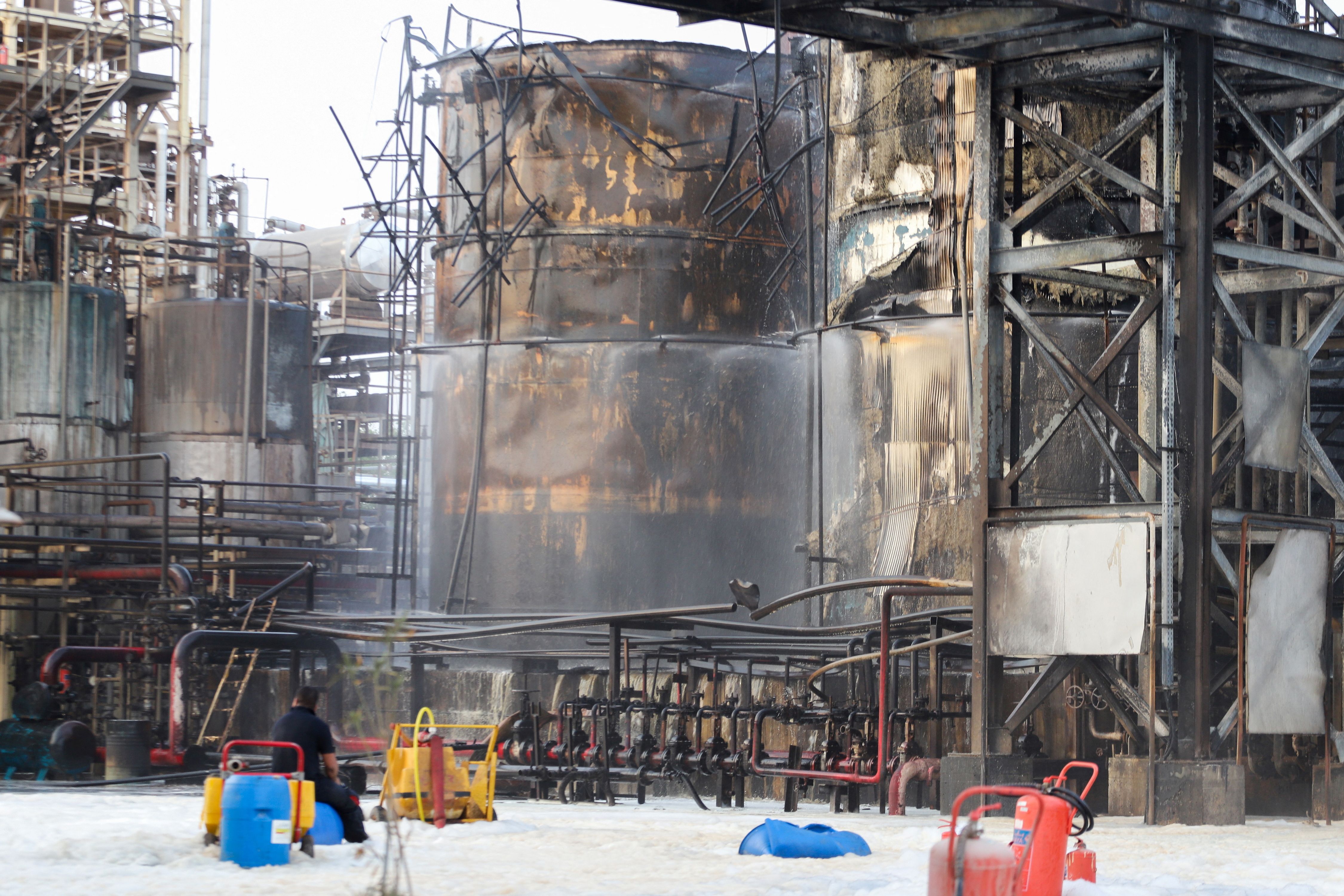 People work to put out a fire at an oil refinery in Bandar Abbas, Iran, July 10, 2023. 