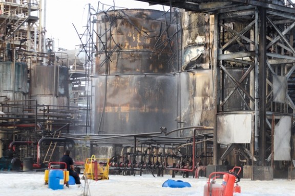 People work to put out a fire at an oil refinery in Bandar Abbas, Iran, July 10, 2023.