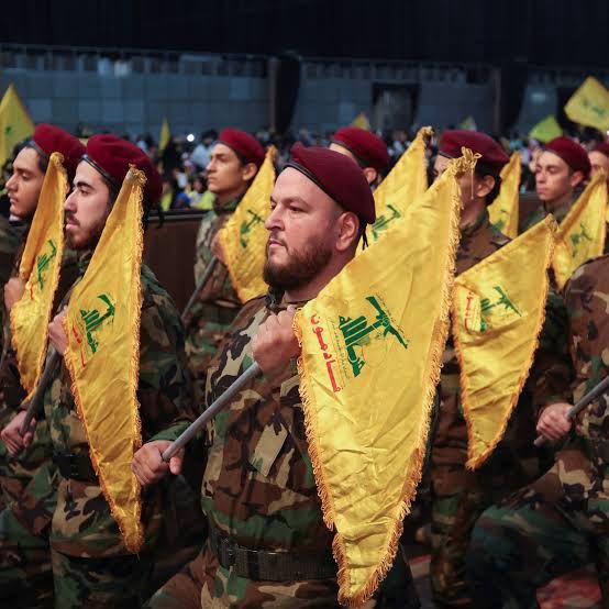 Members of Lebanon's Hezbollah hold flags during a rally (November 2022) 