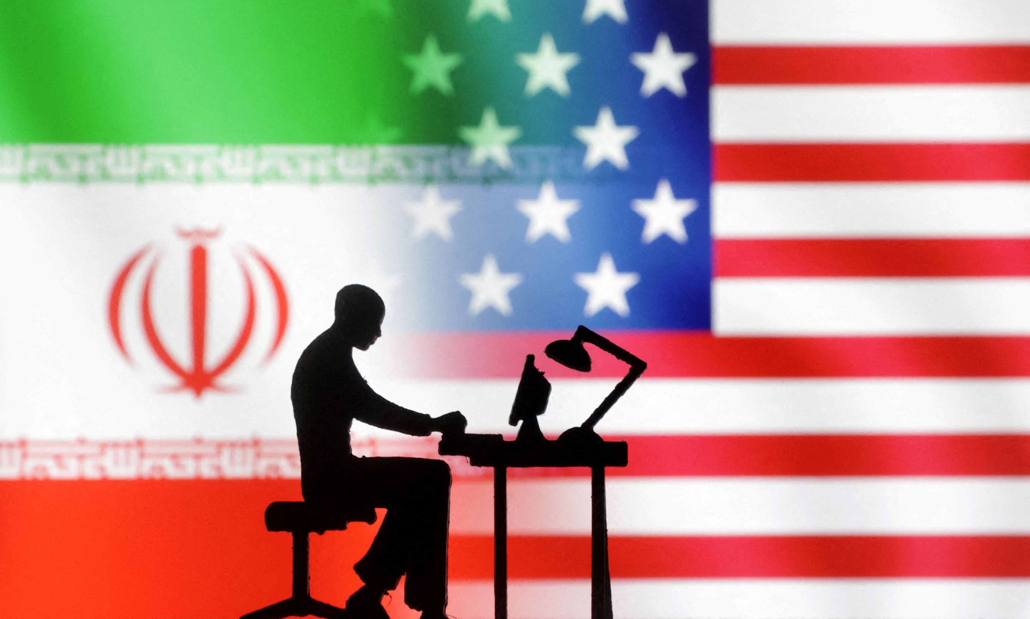 Figurines with computers are seen in front of USA and Iran flags in this illustration taken, September 10, 2022. 