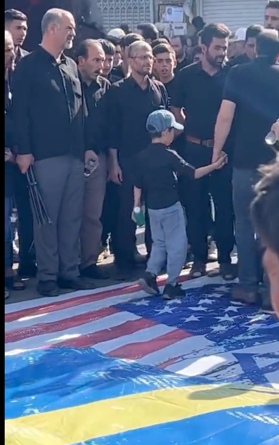 Mourners In Iran Refuse To Trample On Swedish, American Flags