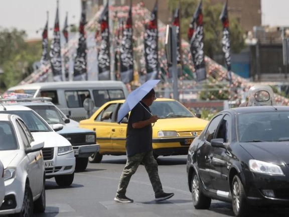 An man walks in a street during the heat surge in Tehran, Iran.