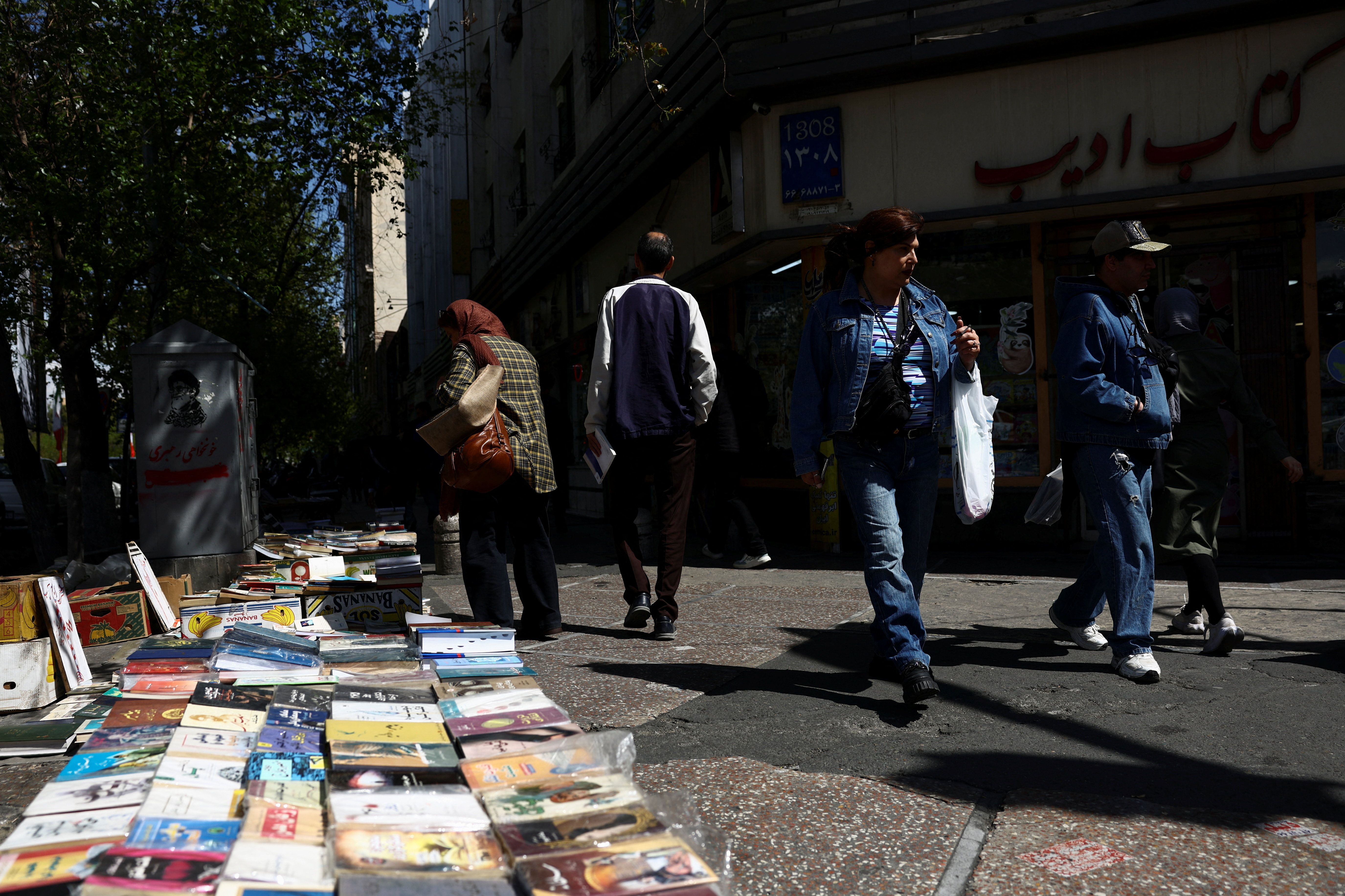 People walk on a street after US President Donald Trump said that he had agreed to a two-week ceasefire with Iran, in Tehran, Iran, April 8, 2026.