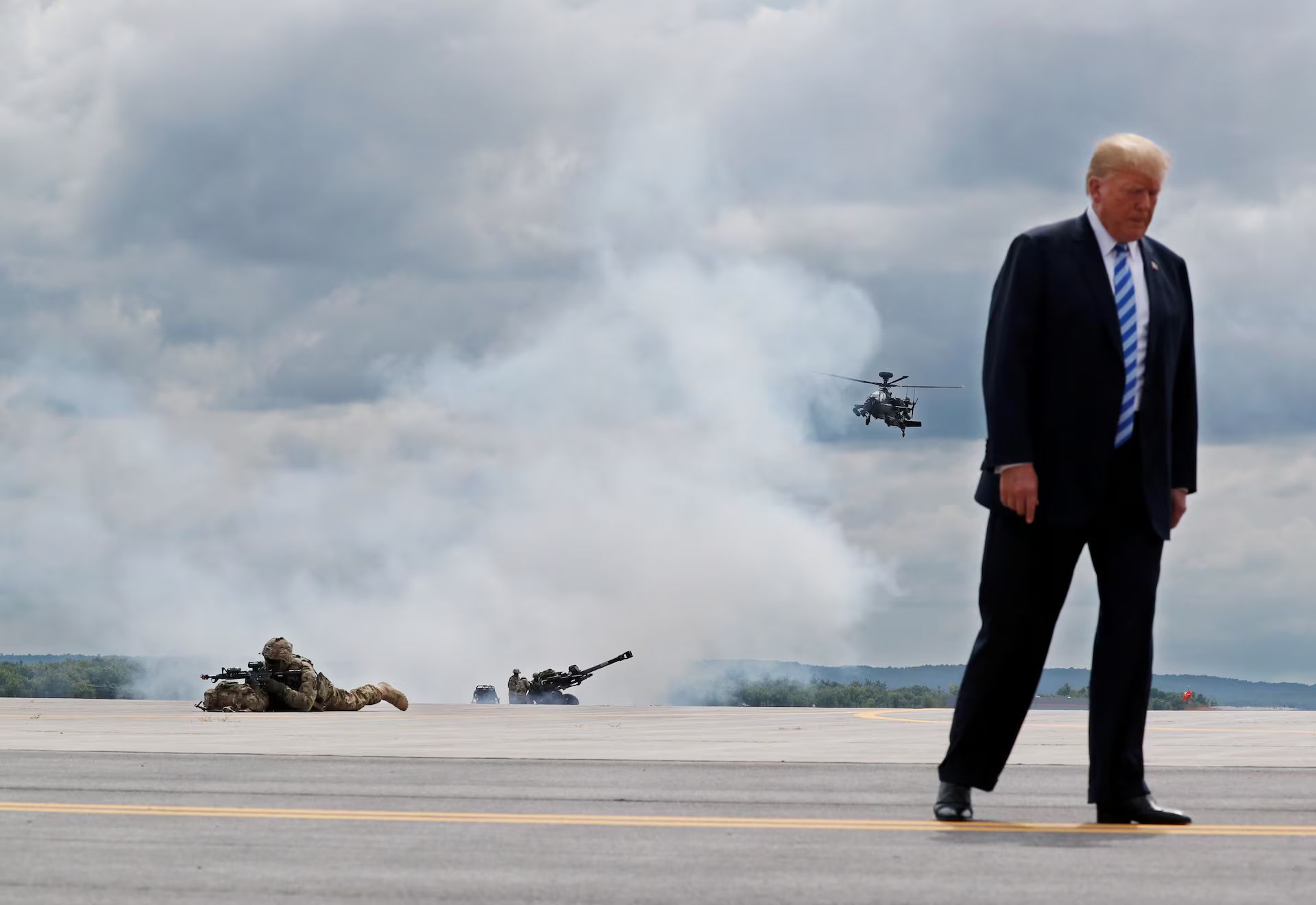 President Donald Trump observes a demonstration with U.S. Army 10th Mountain Division troops, an attack helicopter and artillery, as he visits Fort Drum, New York, in this 2018 file photo