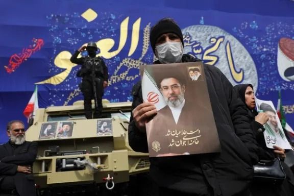 Iranian man holds up photo of Islamic Republic's new Supreme Leader, Mojtaba, the son of the late Ali Khamenei. 