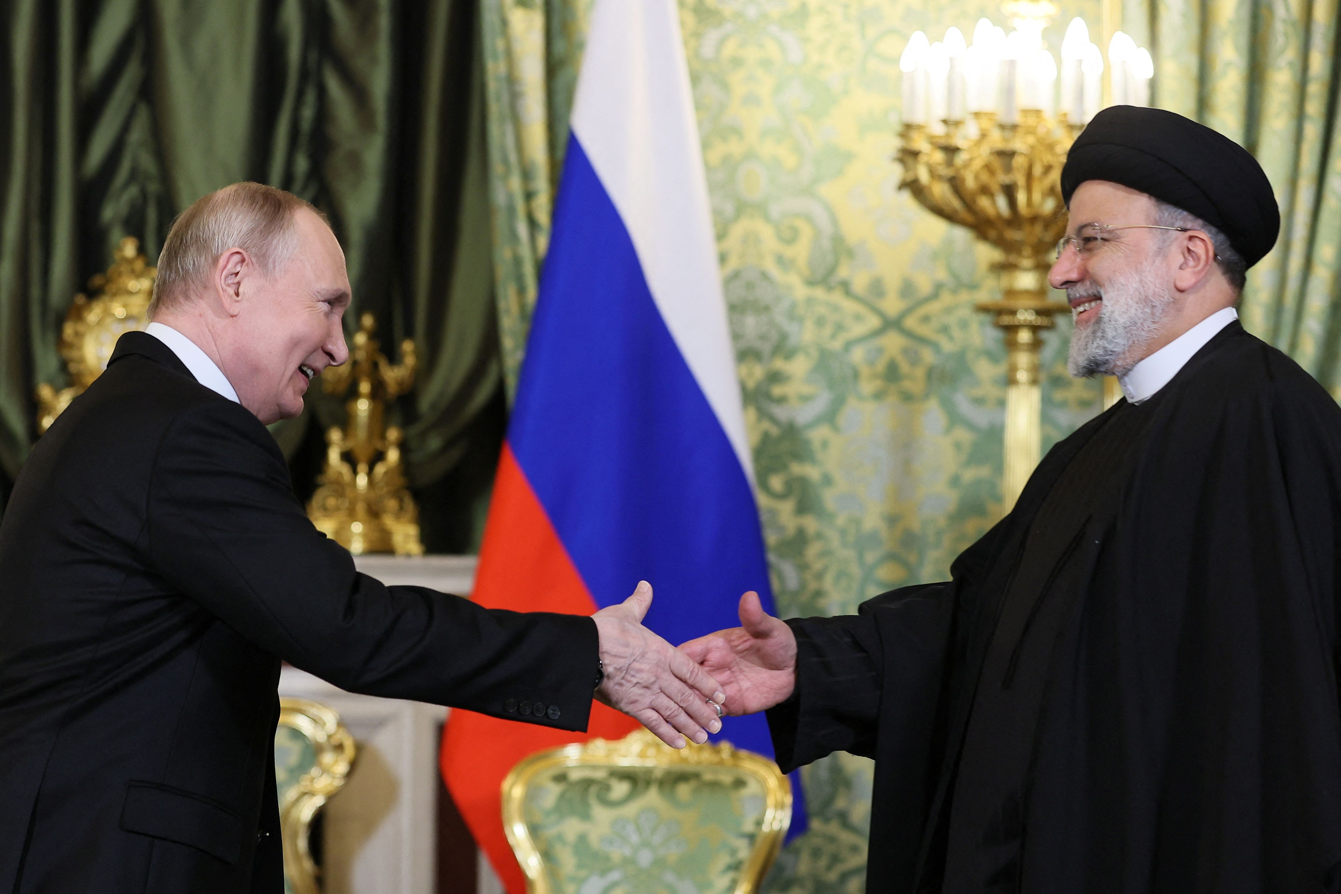 Russian President Vladimir Putin shakes hands with Iranian President Ebrahim Raisi during a meeting in Moscow, Russia December 7, 2023.