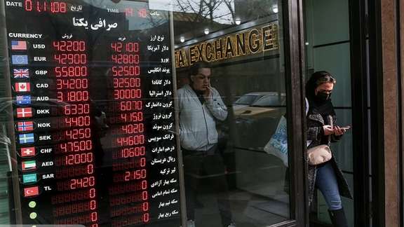 A woman walking out of an exchange office in Iran