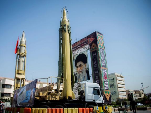 Iran-made missiles on display in front of a huge mural of Iran's Supreme Leader