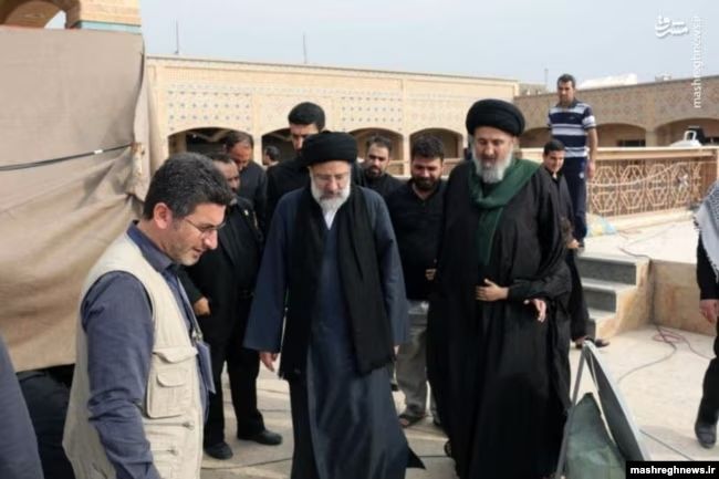 Hameed al-Hussaini, the director Iraq’s section of the Islamic Radio and Television Union (right) and Iran’s President Ebrahim Raisi  (undated)