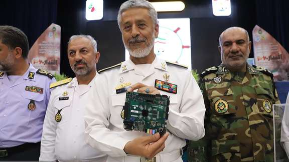 Rear Admiral Habibollah Sayyari, the Coordinating Deputy of the Islamic Republic’s Army, holding a so-called ‘quantum processor’ during a ceremony at the Navy’s Imam Khomeini Maritime University in Noshahr, in the northern province of Mazandaran on June 1, 2023