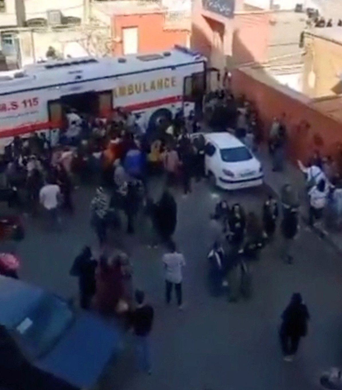 A large "bus ambulance" outside a school taking students to hospital. March 2, 2023