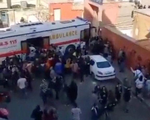 A large "bus ambulance" outside a school taking students to hospital. March 2, 2023