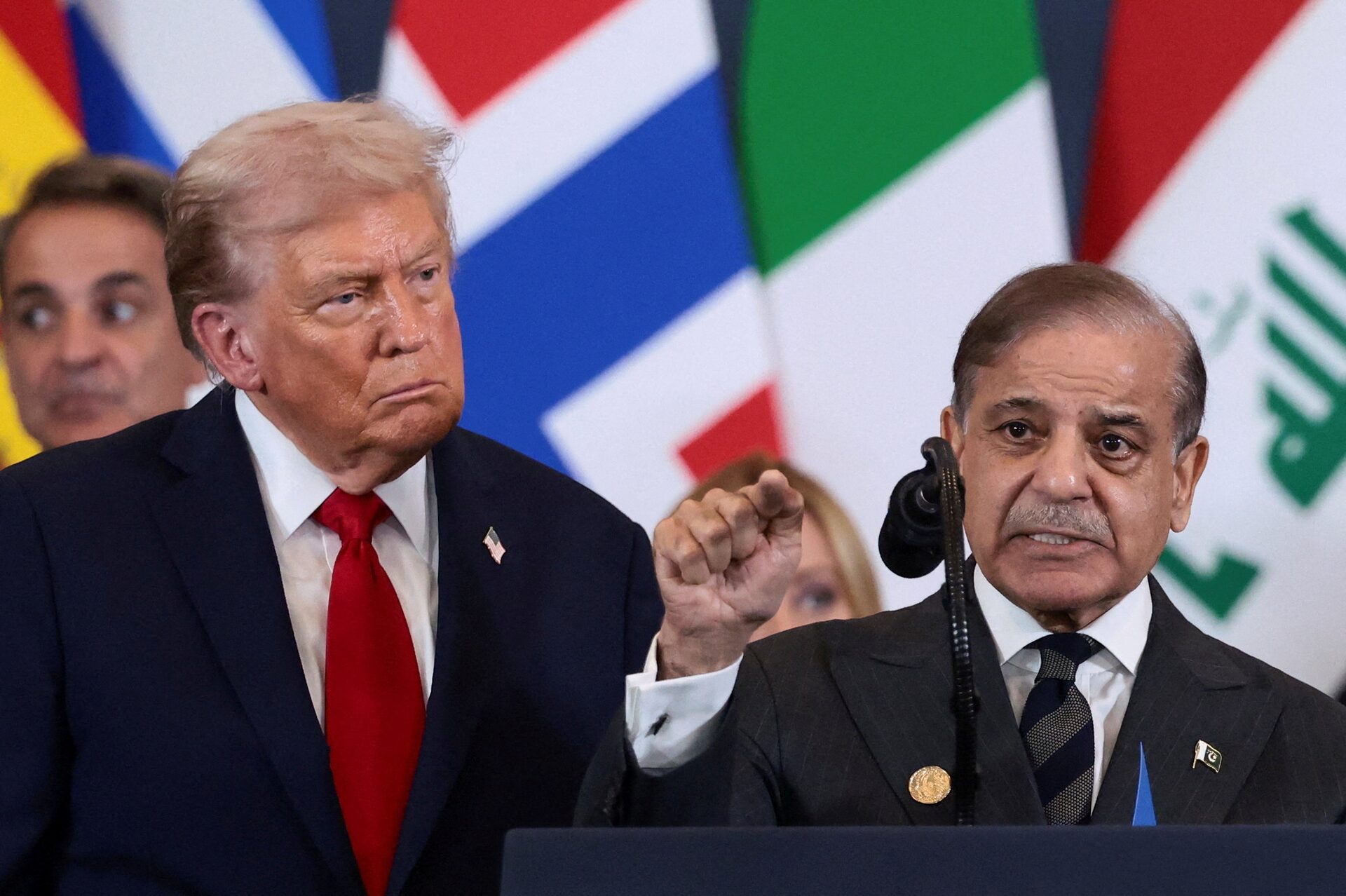 US President Donald Trump looks at Pakistan's Prime Minister Shehbaz Sharif speaking following the official signing of the first phase of the Gaza ceasefire agreement between Israel and Hamas, during a world leaders' summit on ending the Gaza war, in Sharm El-Sheikh, Egypt, October 13, 2025.