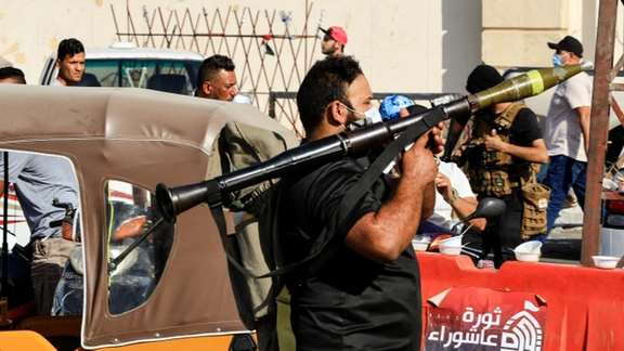 A Sadrist fighter with an RPG in Baghdad on Monday, while wearing a COVID mask. August 30, 2022